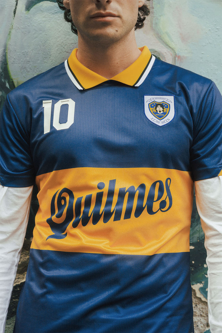 Man wearing a blue and yellow Boca jersey with Maradona branding.