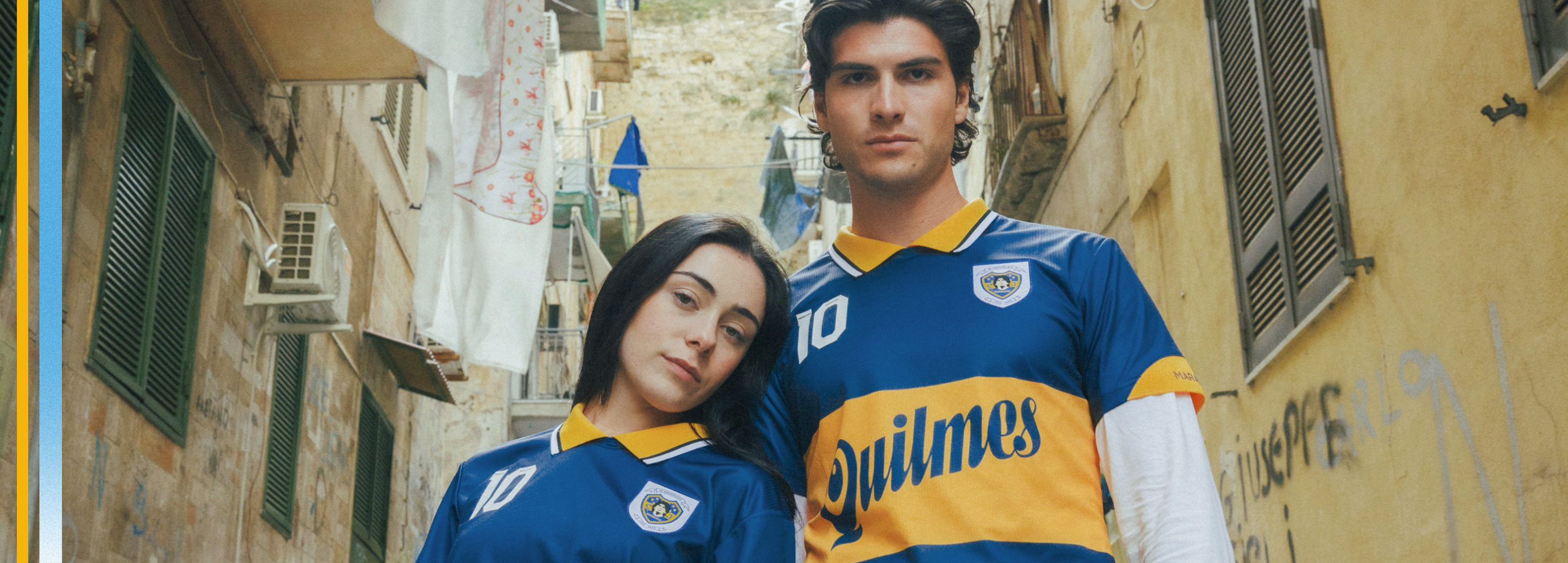 Two people wearing blue and yellow Boca Juniors Maradona sports jerseys in an urban setting.